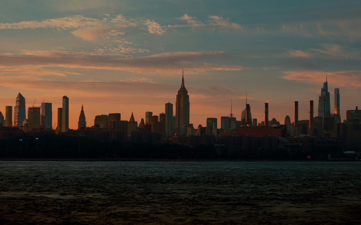 A city skyline across the water at dusk
